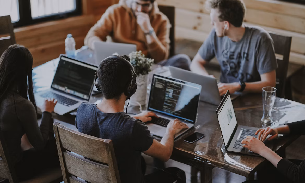 A team working together on laptops in a modern office
