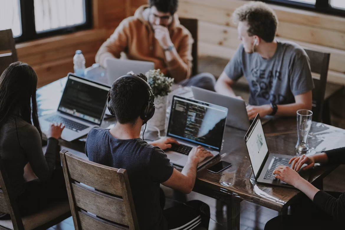 A team working together on laptops in a modern office